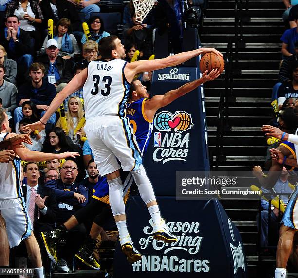 Marc Gasol of the Memphis Grizzlies blocks a shot by Stephen Curry of the Golden State Warriors on December 16, 2014 at the FedEx Forum in Memphis,...