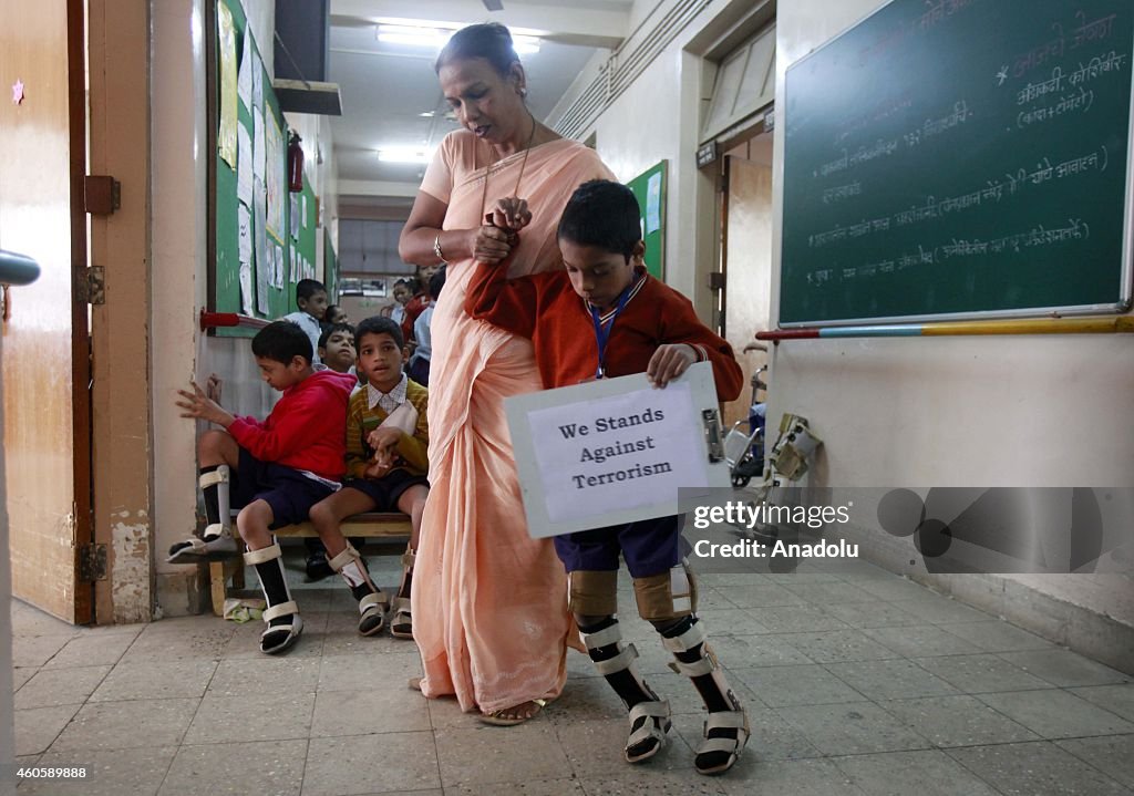 Physically handicapped children hold banners for killed Pakistani students