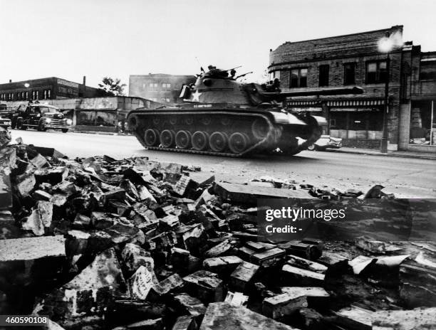 Tank patrols a Detroit street on July 25, 1967 during riots that erupted in Detroit following a police operation.