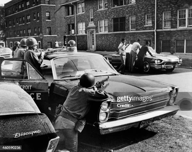 Policemen arrest suspects in a Detroit street on July 25, 1967 during riots that erupted in Detroit following a police operation.