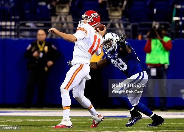 Quarterback Alex Smith of the Kansas City Chiefs is pressured by outside linebacker Robert Mathis of the Indianapolis Colts in the second quarter...