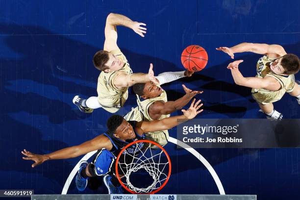 Demetrius Jackson and Pat Connaughton of the Notre Dame Fighting Irish rebound over Jabari Parker of the Duke Blue Devils during the game at Purcell...