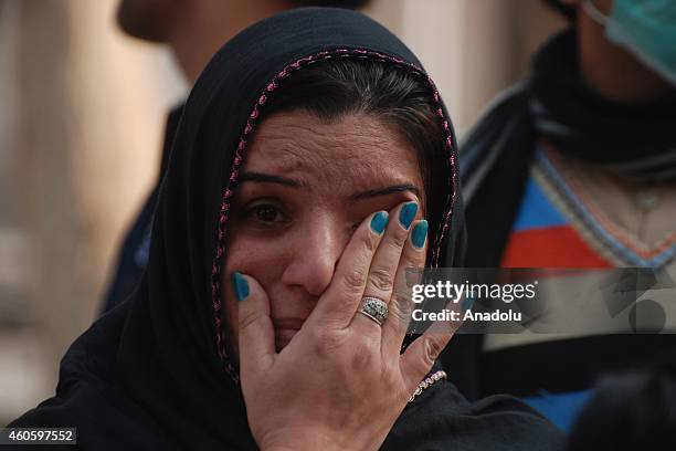 Pakistani woman mourns over the death of a student killed in a Taliban attack at an army-run school, prior to his burial, in Peshawar, Pakistan on...