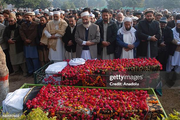 Chief of Pakistan's party of Jamaat-i-Islami Siraj Ul Haq leads the funeral prayers of the victims of a Taliban attack at an army-run school, prior...