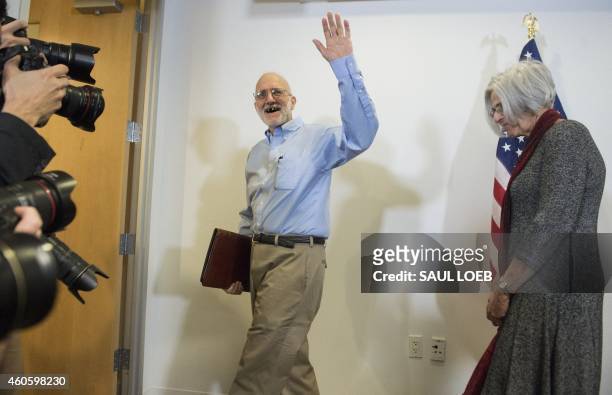 Alan Gross, alongside his wife Judy, waves as he leaves a press conference after being released by Cuba on December 17, 2014 in Washington,DC. Gross,...