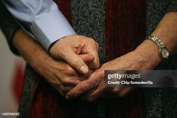 Alan Gross, holding hands with his wife Judy, makes a statement to the news media at the law offices of Gilbert LLC after arriving back in the United...