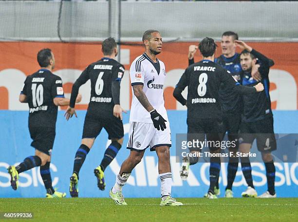 Dennis Aogo of Schalke looks dejected while players of Paderborn celebrate their teams first goal in the background during the Bundesliga match...