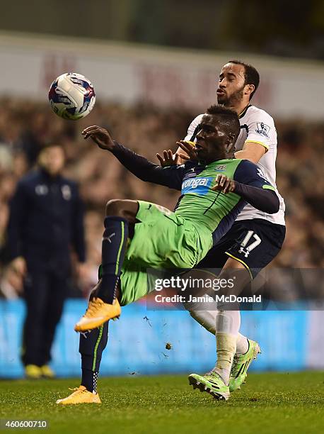 Massadio Haidara of Newcastle United is challenged by Andros Townsend of Tottenham Hotspur during the Capital One Cup Quarter-Final match between...