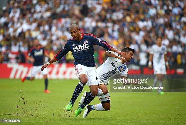 Teal Bunbury of the New England Revolution collides with A.J. DeLaGarza of the Los Angeles Galaxy in the second half during 2014 MLS Cup at StubHub...