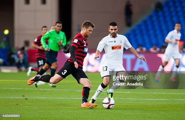 Sid Lamri of ES Setif vies for the ball with Daniel Mullen of WS Wanderers FC during the 2014 FIFA Club World Cup fifth place soccer match between ES...