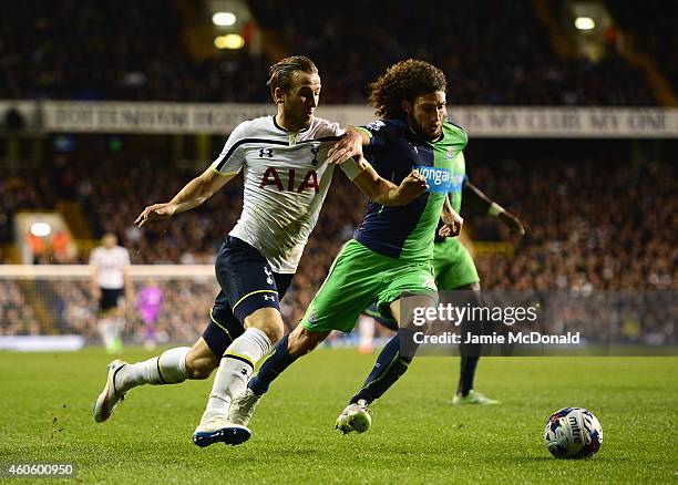 Harry Kane of Tottenham Hotspur takes on Fabricio Coloccini of Newcastle United during the Capital One Cup Quarter-Final match between Tottenham...