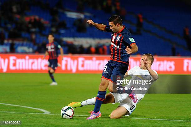Martin Cauteruccio of San Lorenzo vies for the ball with John Irving of Auckland City during the 2014 FIFA Club World Cup semi-final soccer match...