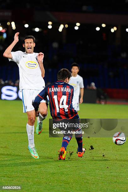 Walter Kannemann of San Lorenzo vies for the ball with Mario Bilen of Auckland City during the 2014 FIFA Club World Cup semi final soccer match...
