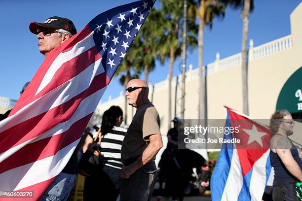 People stand outside the Little Havana restaurant Versailles after news that U.S. Contractor Alan Gross was released from a Cuban prison and U.S....