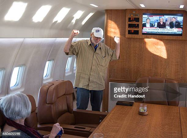 Alan Gross onboard a government plane headed back to the US with his wife, Judy Gross, December 17, 2014. Obama announced plans to restore diplomatic...