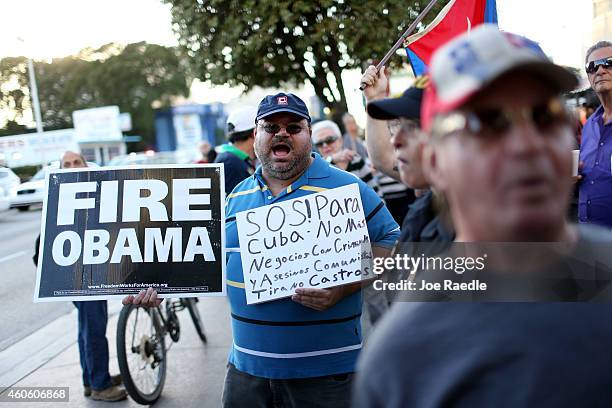 People stand outside the Little Havana restaurant Versailles, as they absorb the news that Alan Gross was released from a Cuban prison and that U.S....