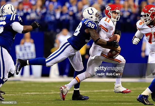 Outside linebacker Robert Mathis of the Indianapolis Colts forces a fumble by quarterback Alex Smith of the Kansas City Chiefs during a Wild Card...