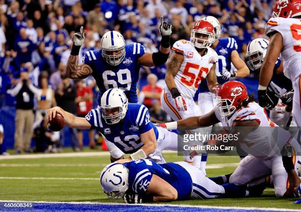 Quarterback Andrew Luck of the Indianapolis Colts scores a touchdown in the fourth quarter after recovering a fumble against the Kansas City Chiefs...