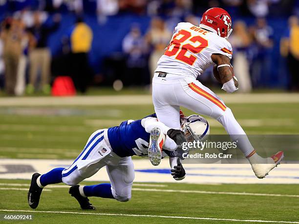 Wide receiver Dwayne Bowe of the Kansas City Chiefs is tackled by defensive back Corey Lynch of the Indianapolis Colts during a Wild Card Playoff...