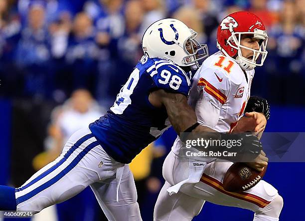 Outside linebacker Robert Mathis of the Indianapolis Colts forces a fumble by quarterback Alex Smith of the Kansas City Chiefs during a Wild Card...