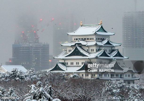 Japan's Nagoya castle is covered with snow in Nagoya in Aichi prefecture, central Japan on December 18, 2014 as heavy snow hit wide areas of Japan....