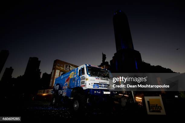 Eduard Nikolaev, Evgeny Yakovlev and Vladimir Rybakov of Russia with team Kamaz Master pose on the official podium in front of The National Flag...