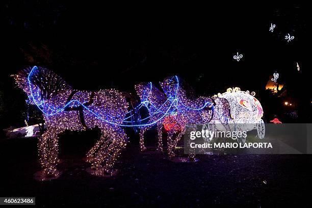 Picture shows Christmas lights representing Cinderella's carriage during the "Luci d'Artista" event on December 17, 2014 in Salerno, southern Italy....
