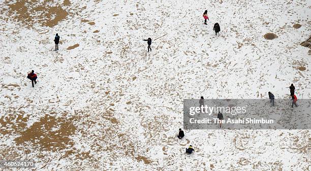 In this aerial image, children play on the snow-covered school ground on December 18, 2014 in Kyoto, Japan. Kyoto recorded minus 1.7 degrees Celsius,...