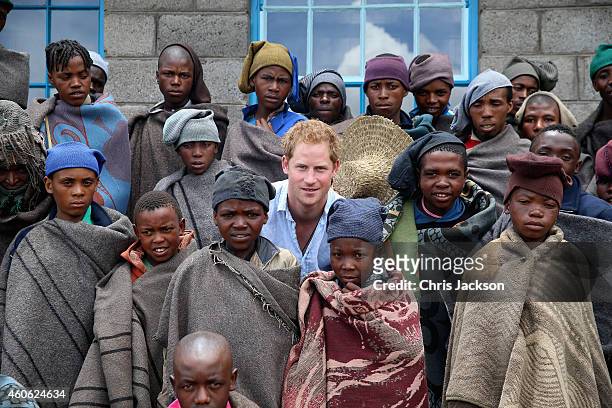 Prince Harry poses for a photograph with herd boys during a visit to a herd boy night school constructed by Sentebale on December 8, 2014 in...
