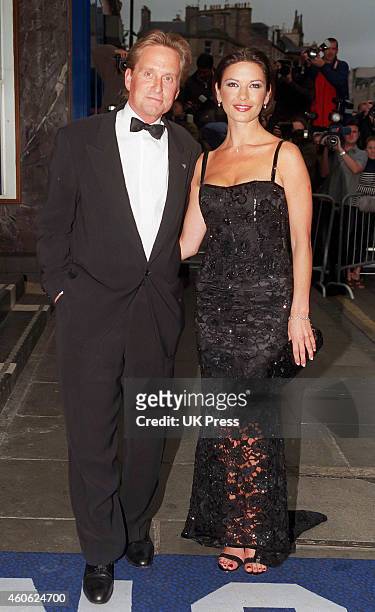 Catherine Zeta Jones, and Michael Douglas attend The Premiere of, Entrapment, in Edinburgh,, on June 30, 1999 in, Edinburgh, Scotland.