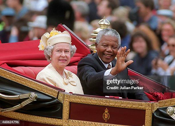 President Nelson Mandela of South Africa, with Queen Elizabeth II, taking a carriage ride along the Mall to Buckingham Palace during a State Visit to...