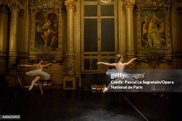 Young Ballerinas warm up in the Opera Garnier foyer before rehersal for the 'Generale' performance at Opera Garnier on April 12, 2013 in Paris,...