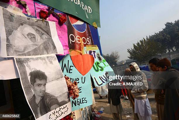 Pakistan mourners gather outside the gate of an army-run school which was attacked by militants in Peshawar on December 18, 2014. Pakistan is...