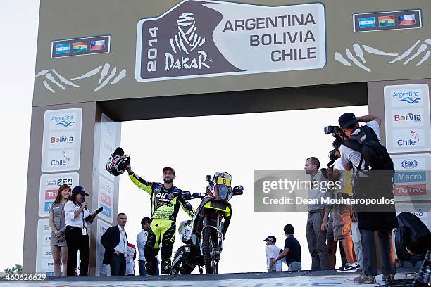 David Casteu of France for the ELF KTM Factory Team waves to fans on the official podium in front of The National Flag Memorial during the 2014 Dakar...