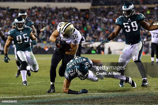 Lance Moore of the New Orleans Saints scores a 24 yard touchdown thrown by Drew Brees in the third quarter Cary Williams of the Philadelphia Eagles...