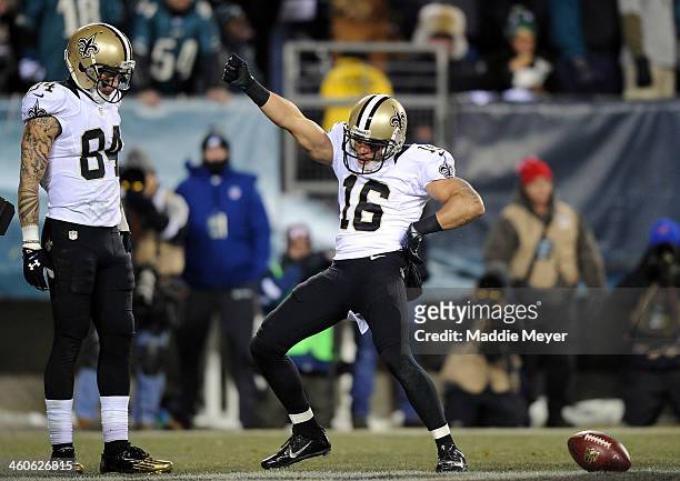 Lance Moore of the New Orleans Saints celebrates with teammate Kenny Stills after scoring a 24 yard touchdown thrown by Drew Brees in the third...