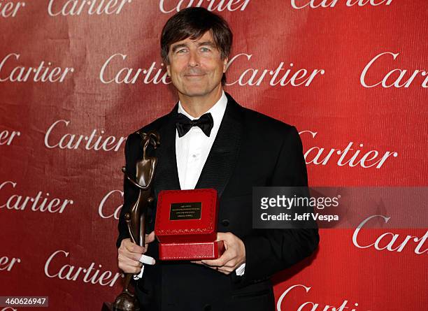 Composer Thomas Newman poses with the Frederick Loewe Award for Film Composing for "Saving Mr. Banks" backstage during the 25th annual Palm Springs...