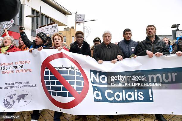 French humorist Guy Bedos , French writer, journalist and activist Rokhaya Diallo and protesters hold a banner showing a crossed out logo of a wall...