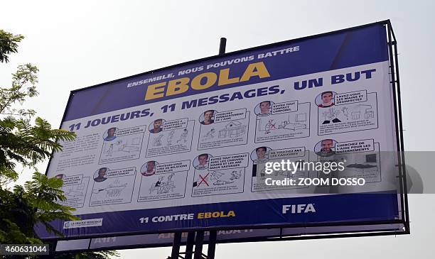 Picture taken on December 17, 2014 shows a board bearing the "11 against Ebola" campaign of World football governing body FIfa, a joint venture with...