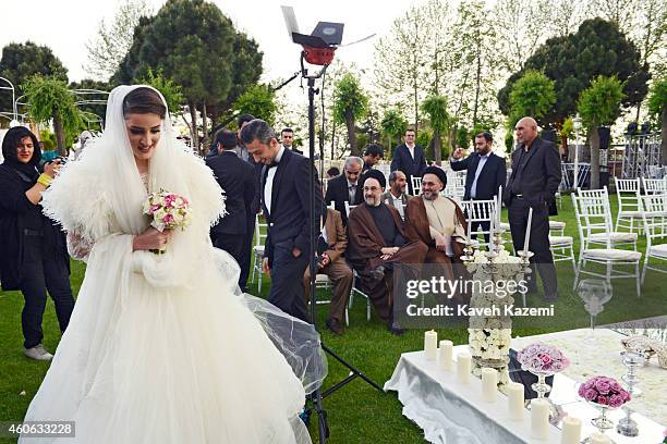 Parmis Taheri and Mostafa Aghaei during their wedding ceremony at the social club of Mining & Industry Bank on May 1, 2014 in Tehran, Iran. Parmis is...