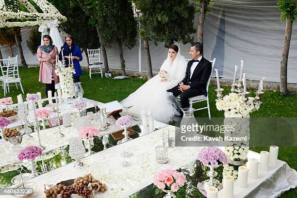 Parmis Taheri and Mostafa Aghaei during their wedding ceremony at the social club of Mining & Industry Bank on May 1, 2014 in Tehran, Iran. Parmis is...