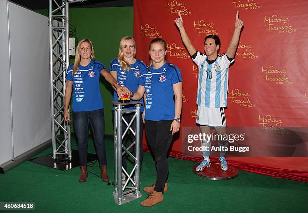 Jennifer Cramer, Tabea Kemme and Pauline Bremer of the women's national football team of Germany unveil a wax figure of the multiple world player of...