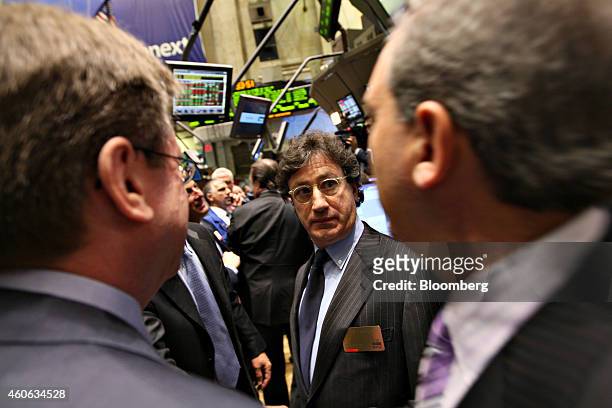 Louis Camilleri, chairman and chief executive officer of Philip Morris International Inc., talks with colleagues after trading the first shares of...
