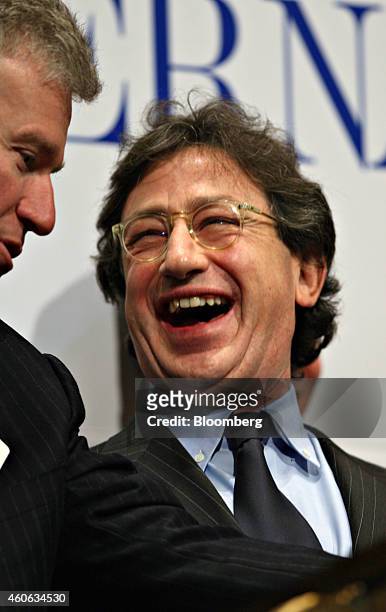 Louis Camilleri, chairman and chief executive officer of Philip Morris International Inc., right, laughs as he talks with Duncan Niederauer, chief...