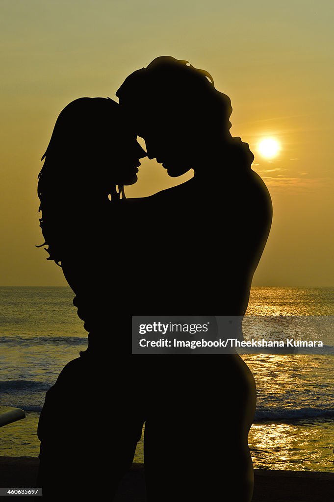 Mature couple kising in sundown