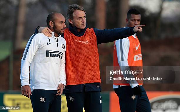 Internazionale Milano coach Roberto Mancini issues instructions to his player Cicero Moreira Jonathan during FC Internazionale training session at...