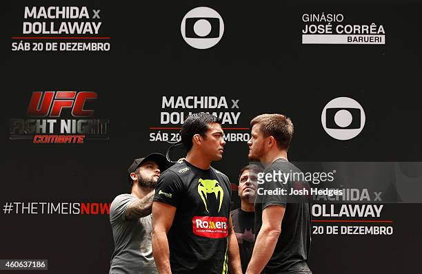 Opponents Lyoto Machida of Brazil and CB Dollaway of the United States face off during an open training session for fans and media at Allianz Parque...