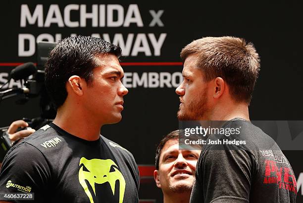 Opponents Lyoto Machida of Brazil and CB Dollaway of the United States face off during an open training session for fans and media at Allianz Parque...