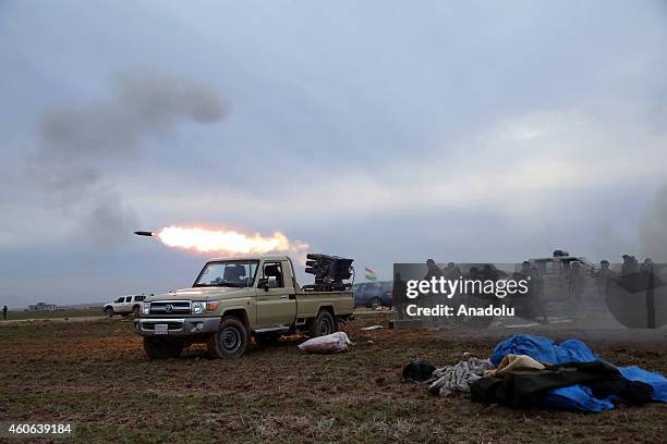 Peshmerga fighters attack Islamic State of Iraq and Levant with missiles during the clashes in Sinun district of Mosul, northern Iraq as Peshmerga...