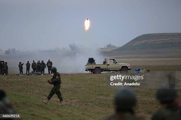 Peshmerga fighters attack Islamic State of Iraq and Levant with missiles during the clashes in Sinun district of Mosul, northern Iraq as Peshmerga...